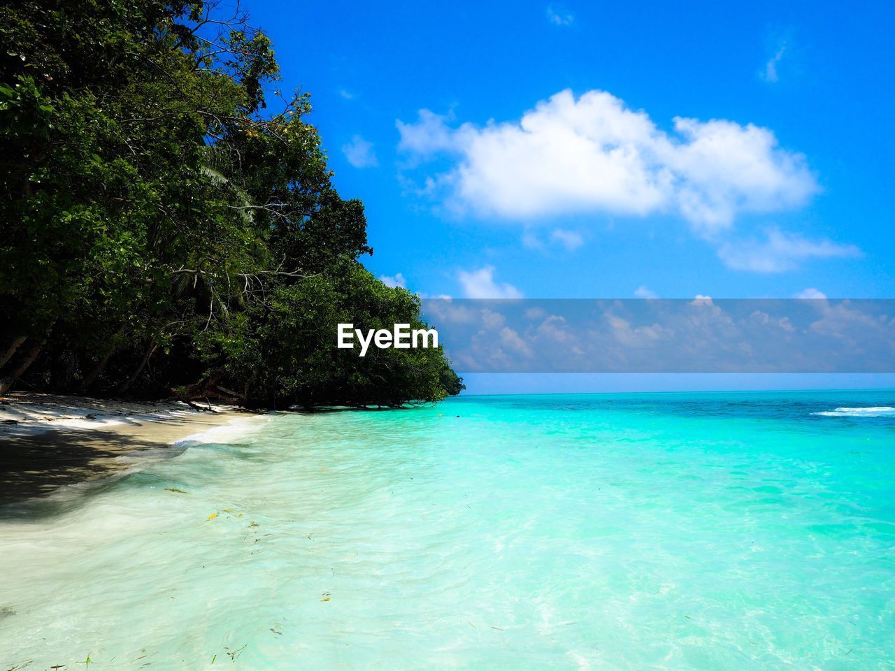 Scenic view of sea against blue sky