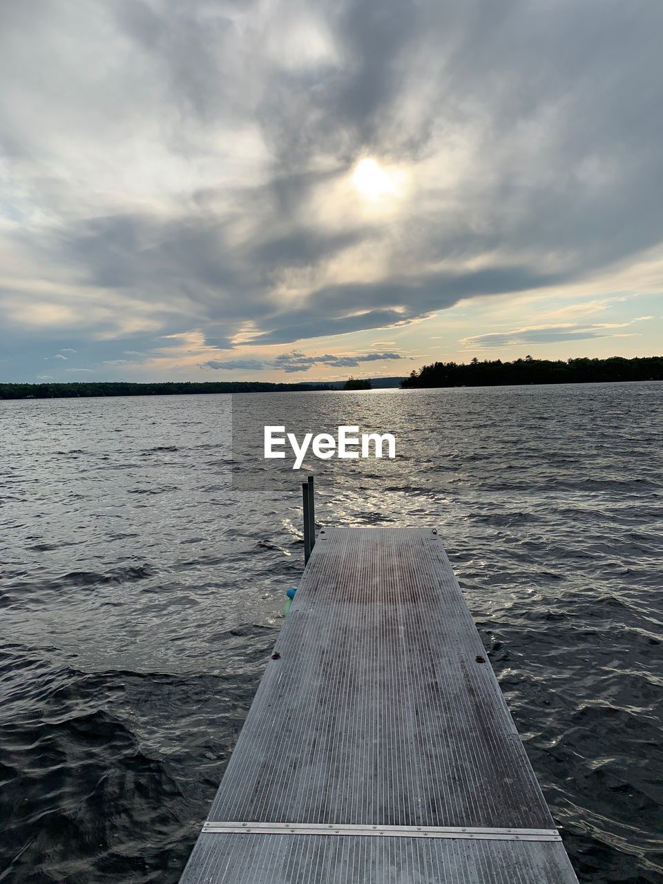 Pier over sea against sky during sunset