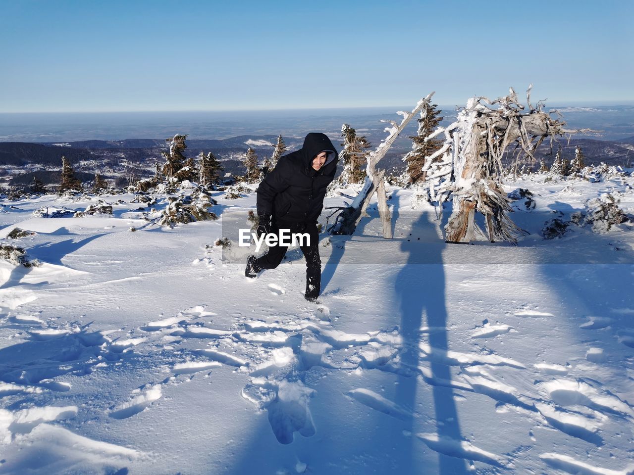 Full length of woman on snowy field against sky