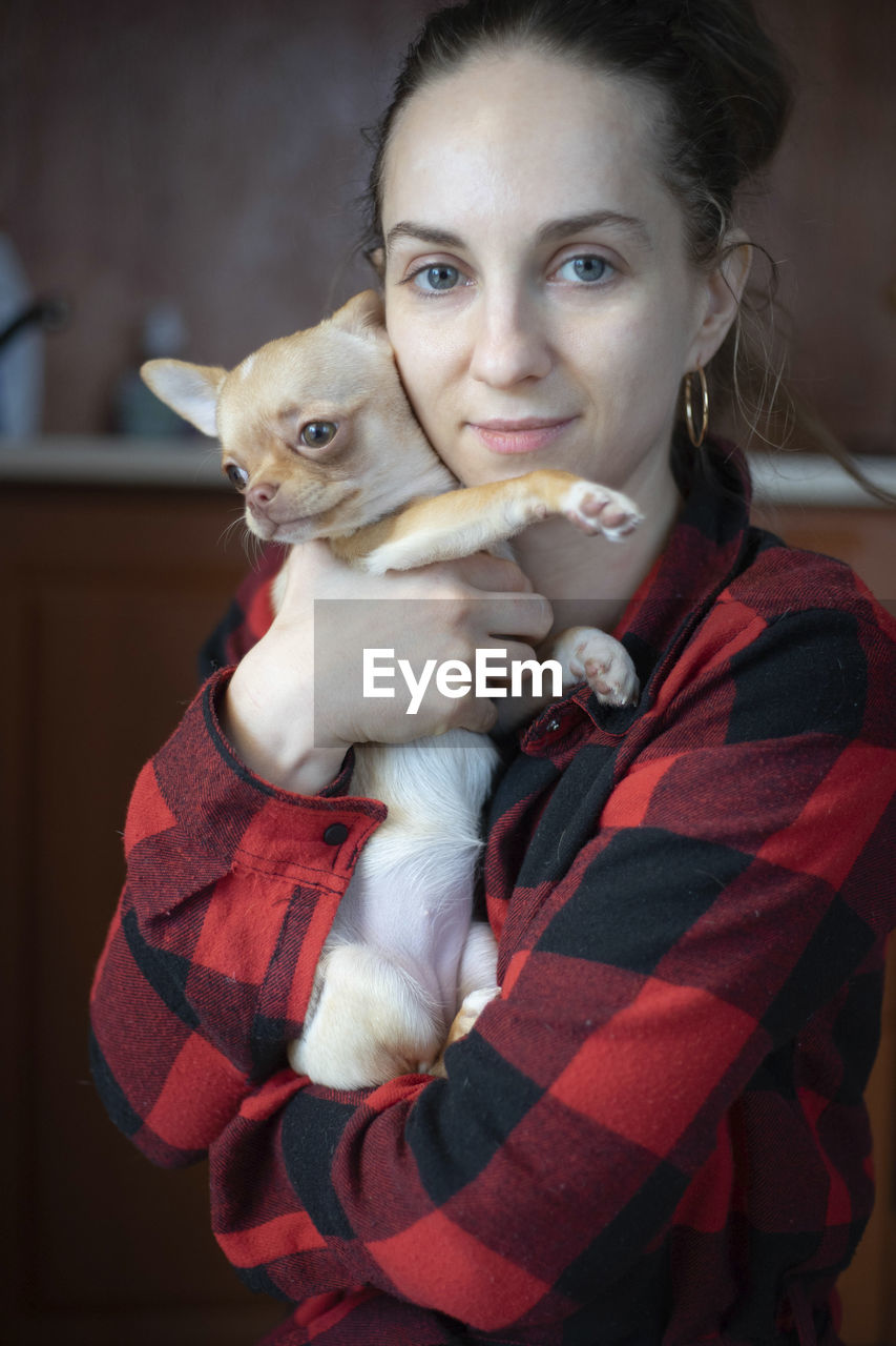 Woman holding a small dog