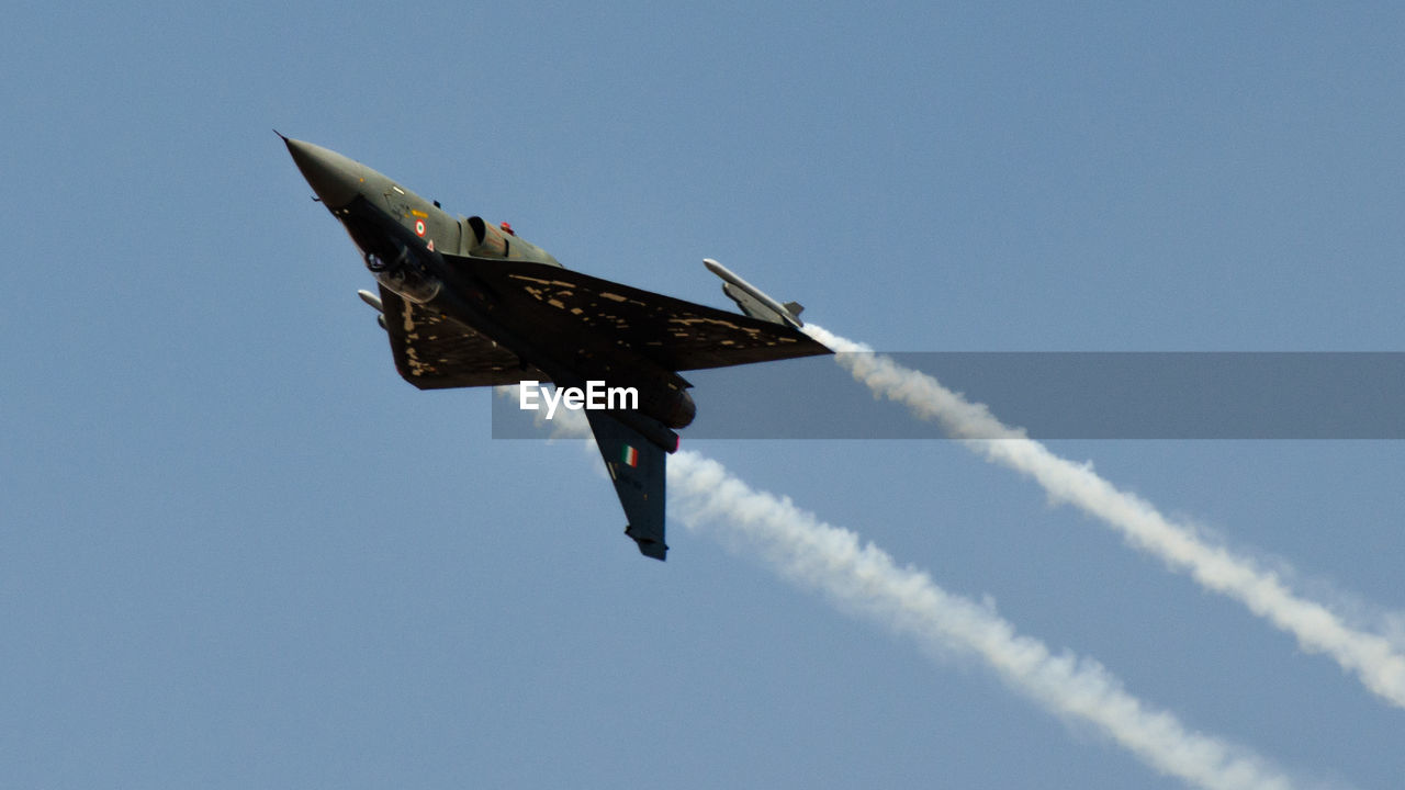 LOW ANGLE VIEW OF AIRPLANE FLYING IN SKY