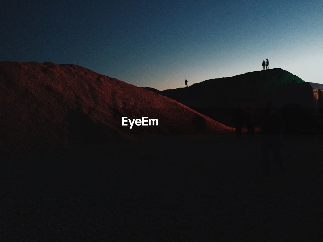 Low angle view of silhouette mountains against sky at dusk