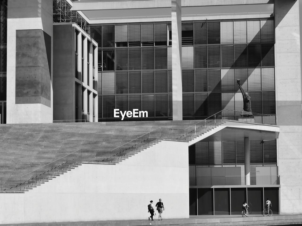 PEOPLE WALKING ON MODERN BUILDING