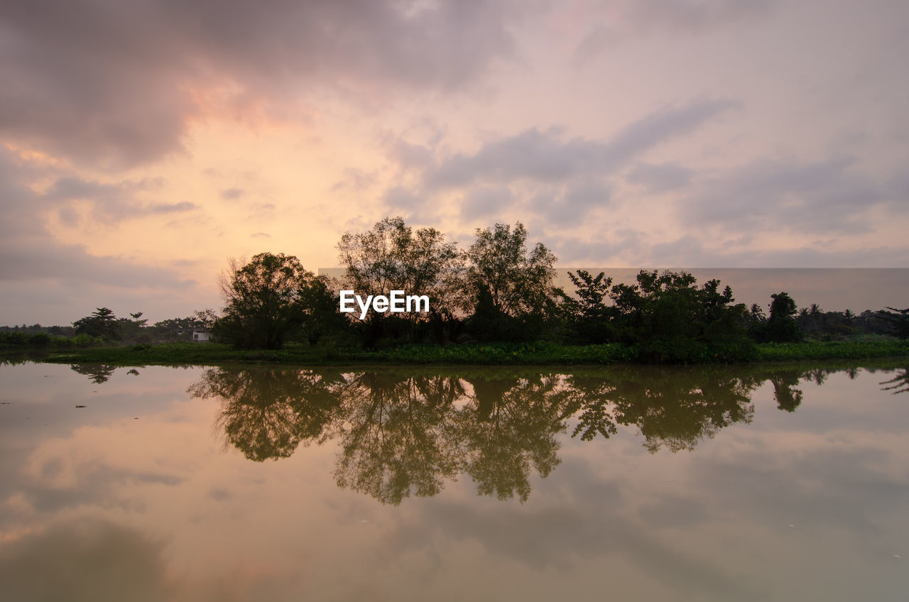 reflection, water, nature, sky, morning, cloud, tree, beauty in nature, plant, lake, environment, tranquility, scenics - nature, landscape, dawn, tranquil scene, sunrise, no people, outdoors, twilight, sun, reflection lake, sunlight, land, travel destinations, travel, idyllic, non-urban scene, horizon, orange color, forest, rural scene, multi colored