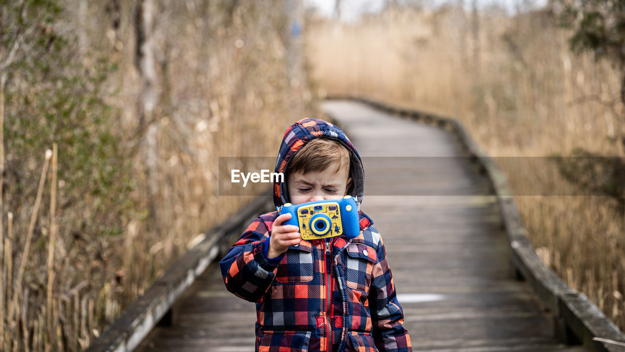 A boy captures a picture.
