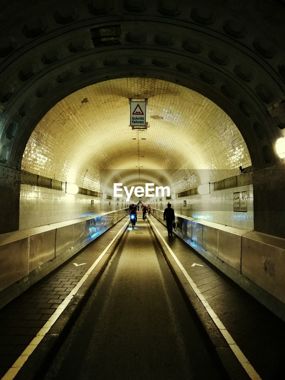 People walking in underground walkway subway station