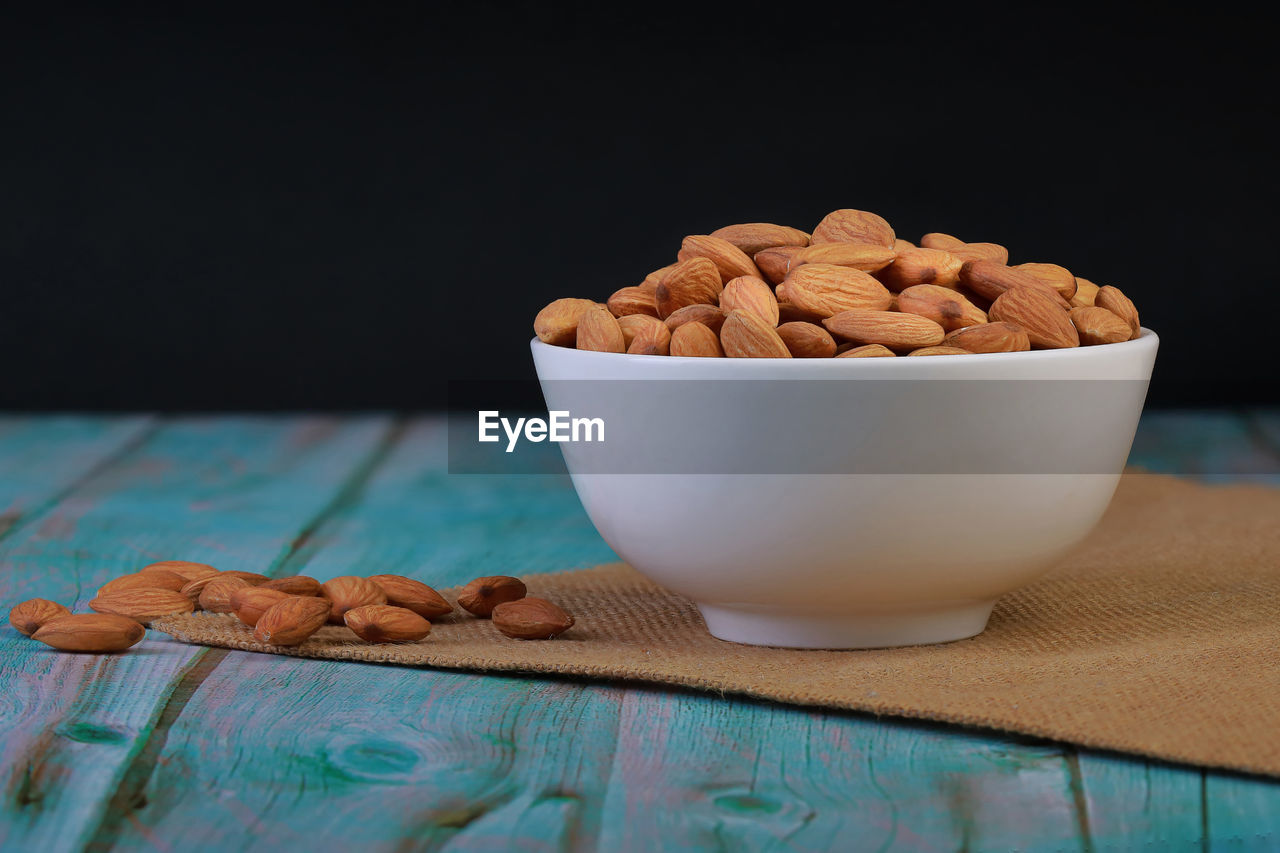 Almond in a cup, placed on a wooden floor for cooking