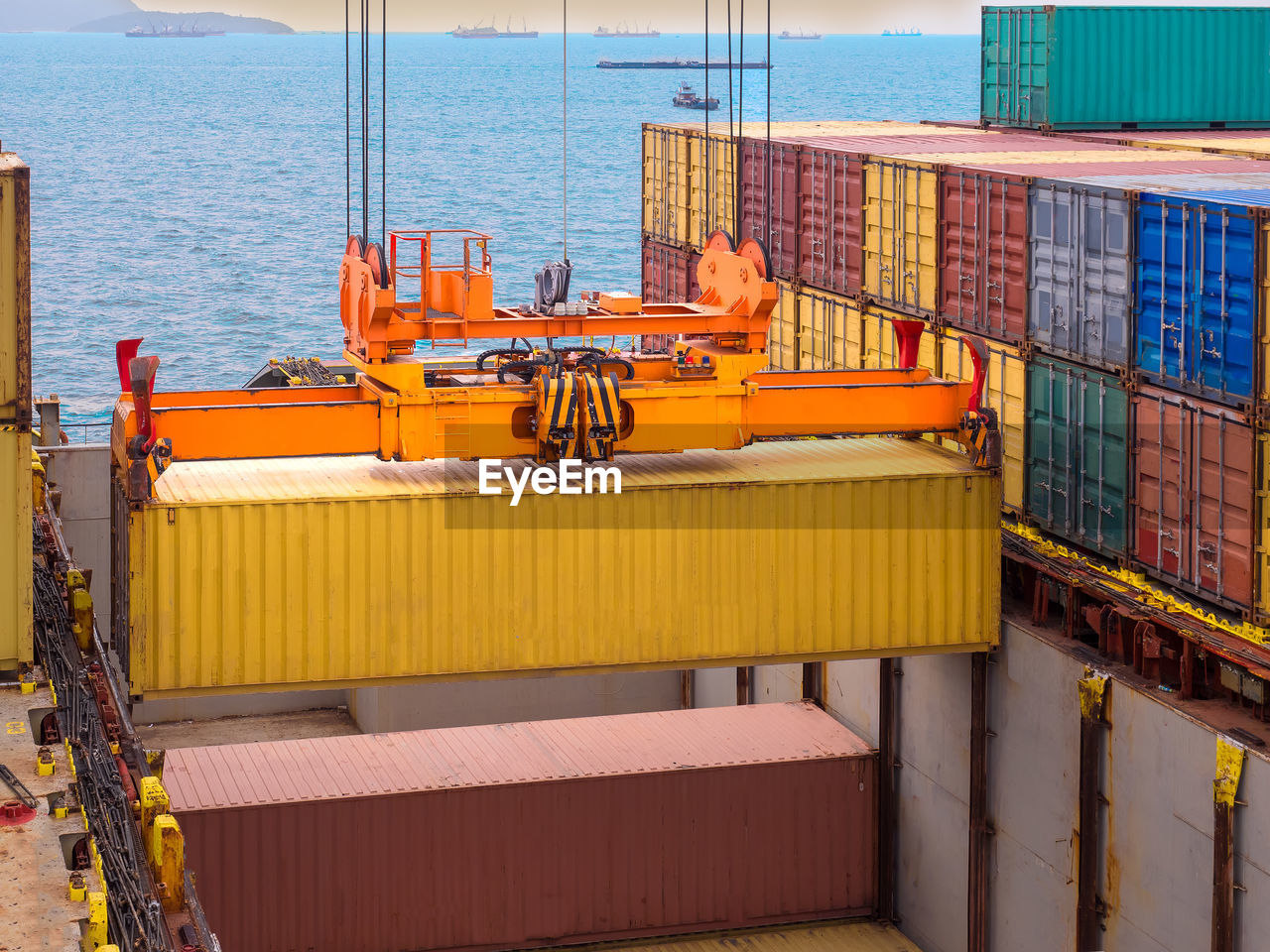 Containers are discharging from vessel by port crane at port of thailand,