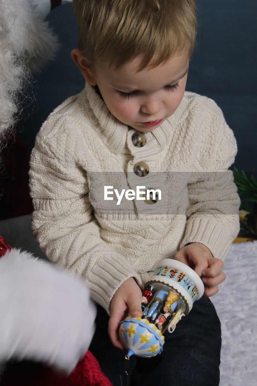 Boy holding toy during christmas