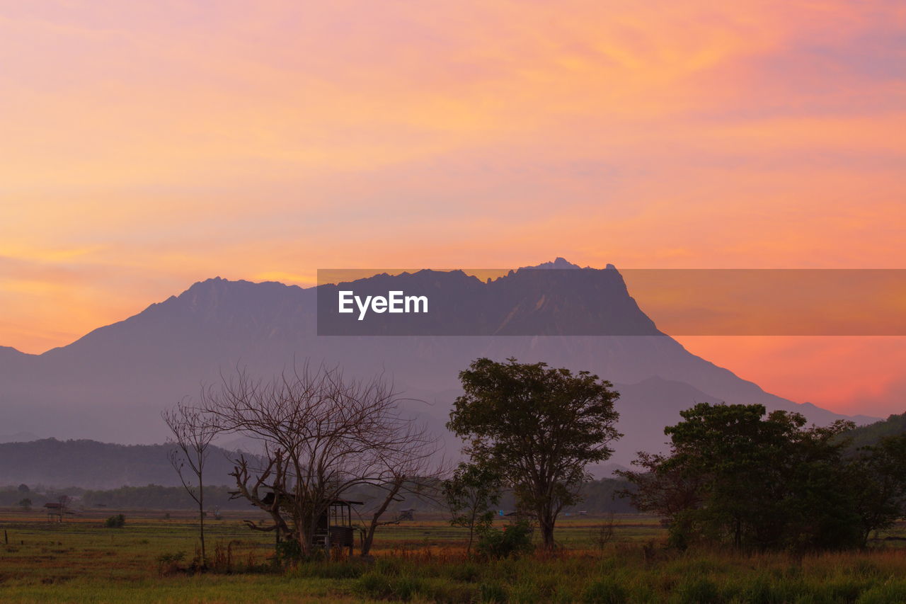 SCENIC VIEW OF MOUNTAIN AGAINST SKY DURING SUNSET