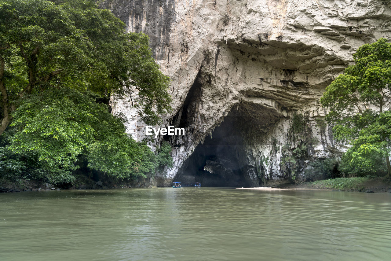 SCENIC VIEW OF WATERFALL AMIDST ROCKS