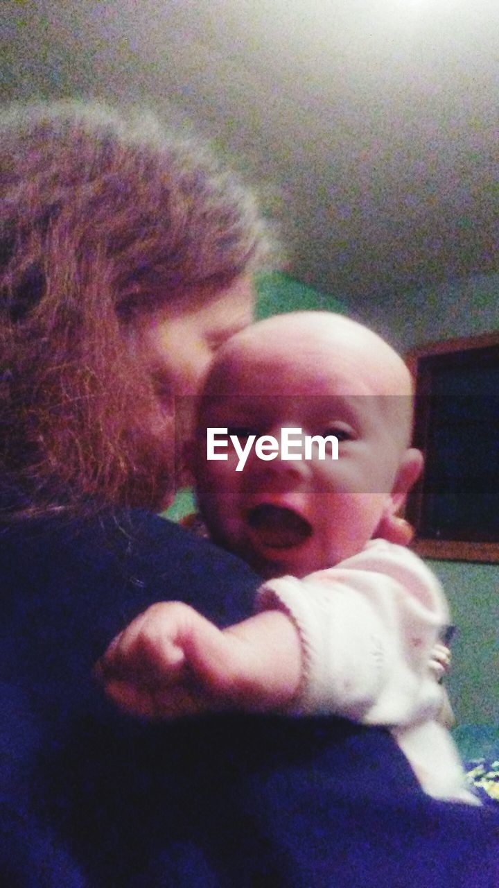 CLOSE-UP OF BABY GIRL WITH HANDS