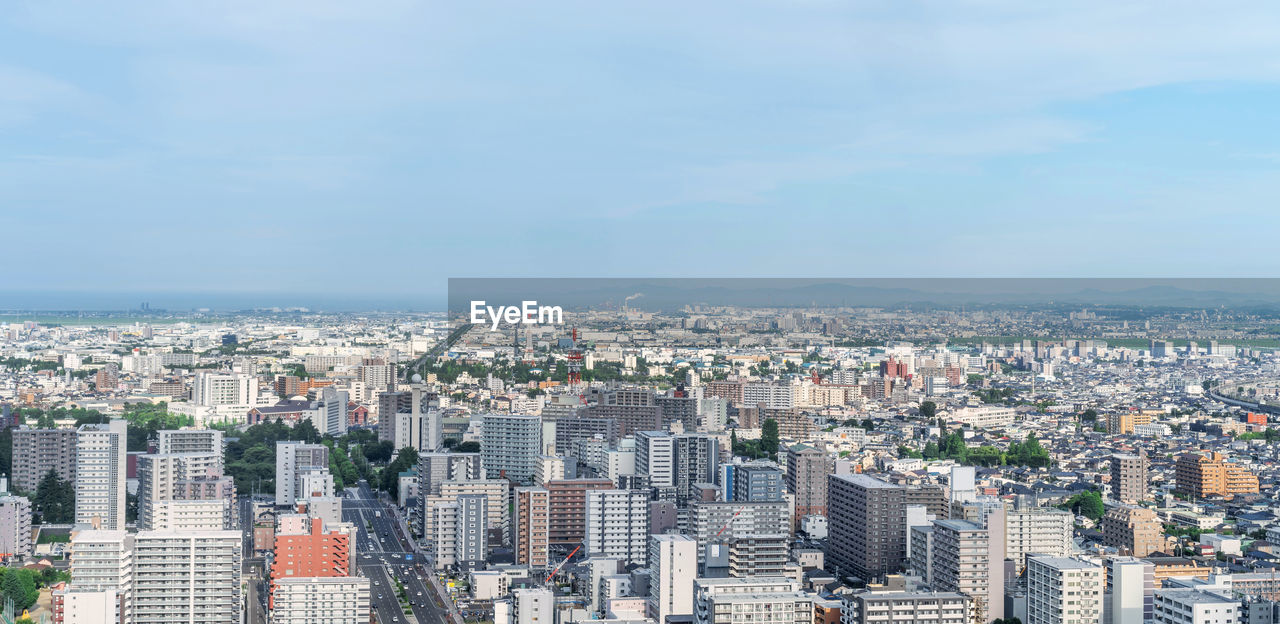 HIGH ANGLE VIEW OF BUILDINGS AGAINST SKY