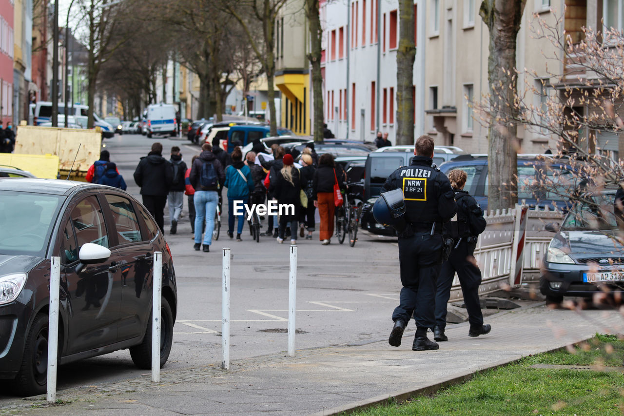 PEOPLE ON STREET AMIDST CITY