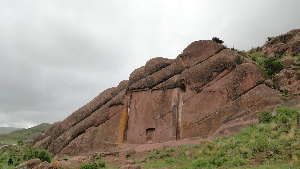 Scenic view of rocks against cloudy sky