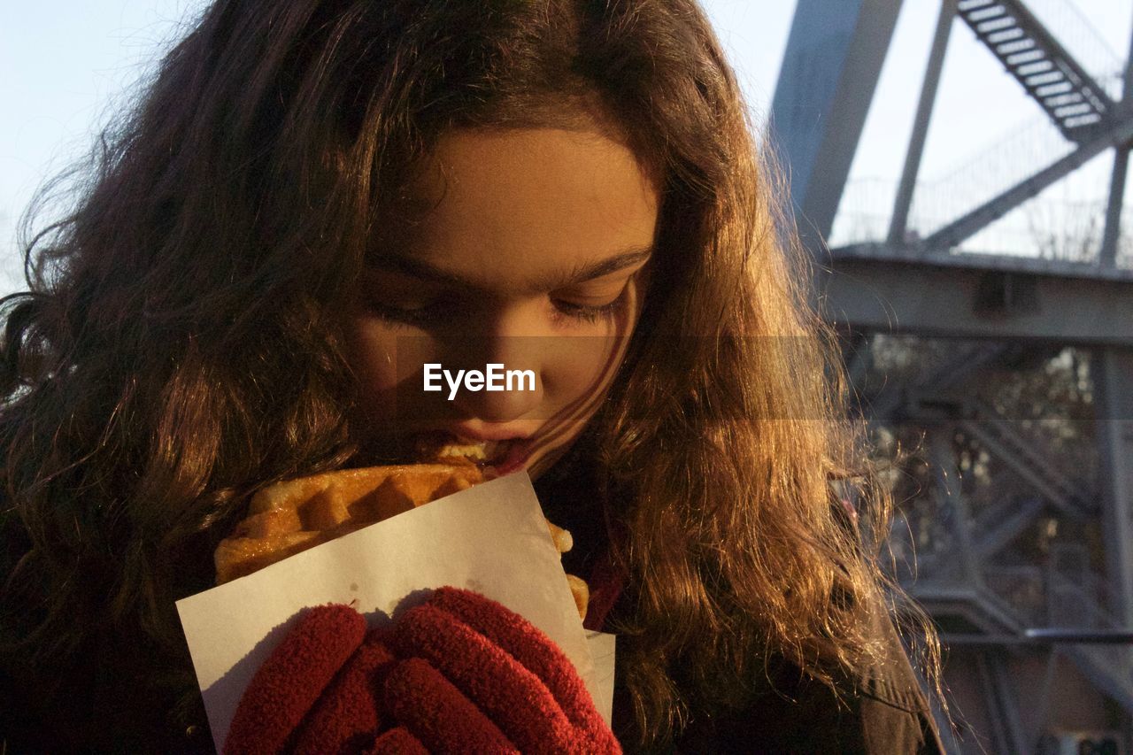 Close-up of girl eating waffle