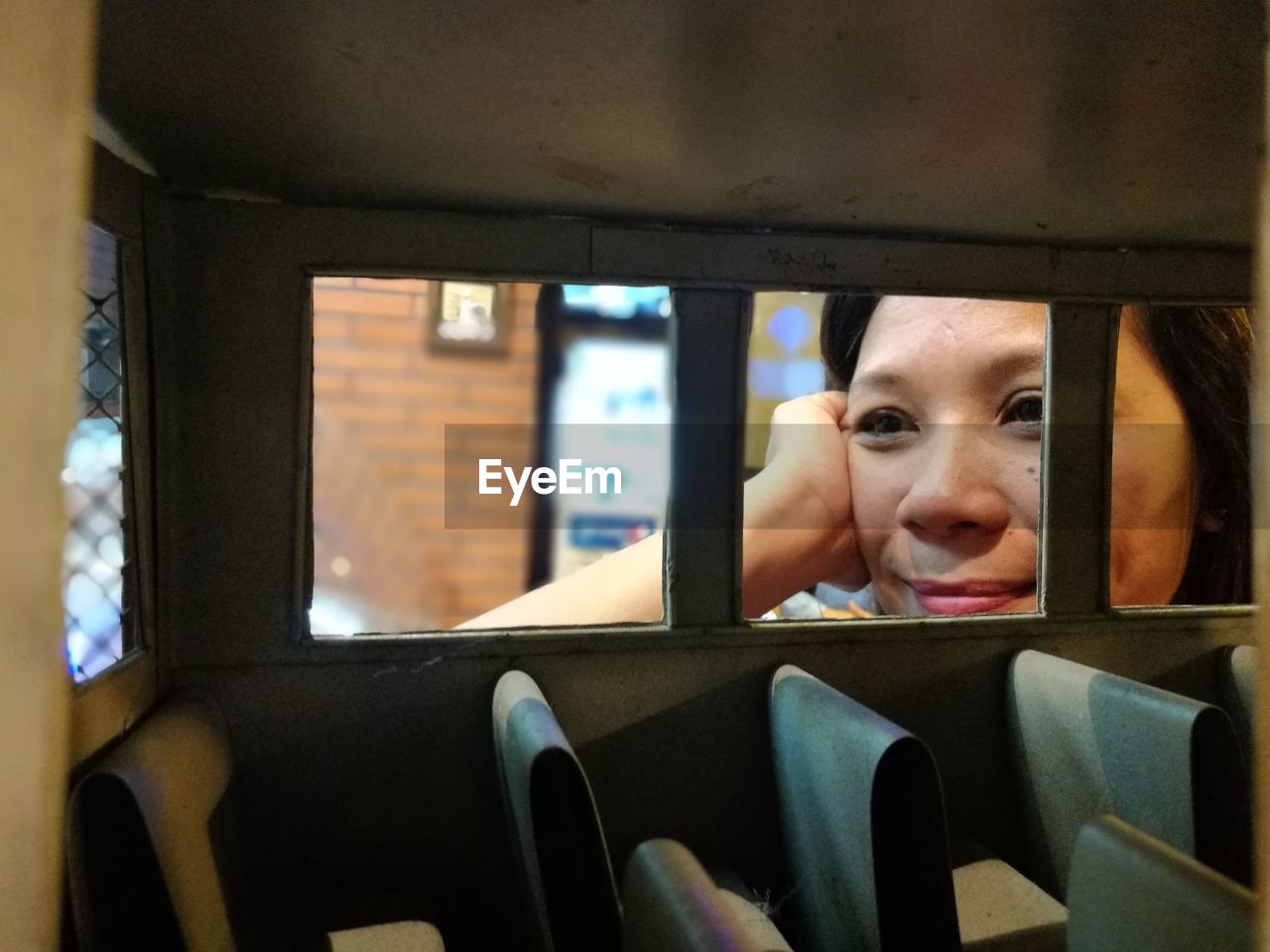 PORTRAIT OF CUTE BOY LOOKING THROUGH WINDOW IN BUS