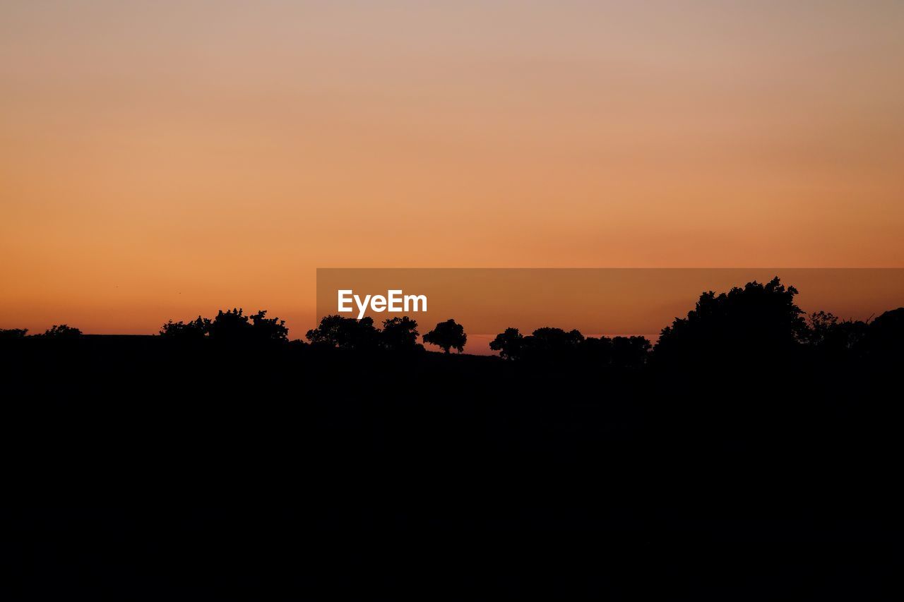 SCENIC VIEW OF SILHOUETTE LANDSCAPE AGAINST SKY DURING SUNSET