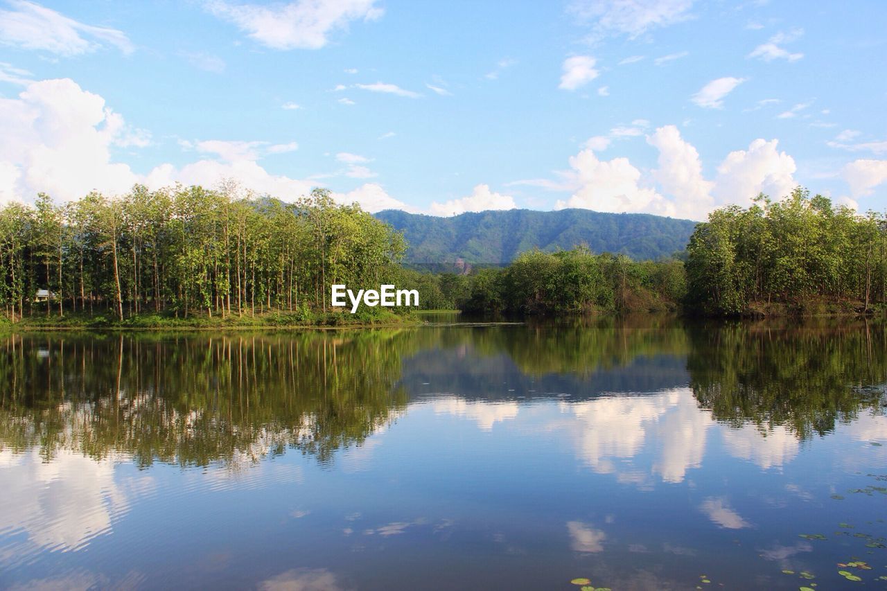 SCENIC VIEW OF CALM LAKE AGAINST SKY