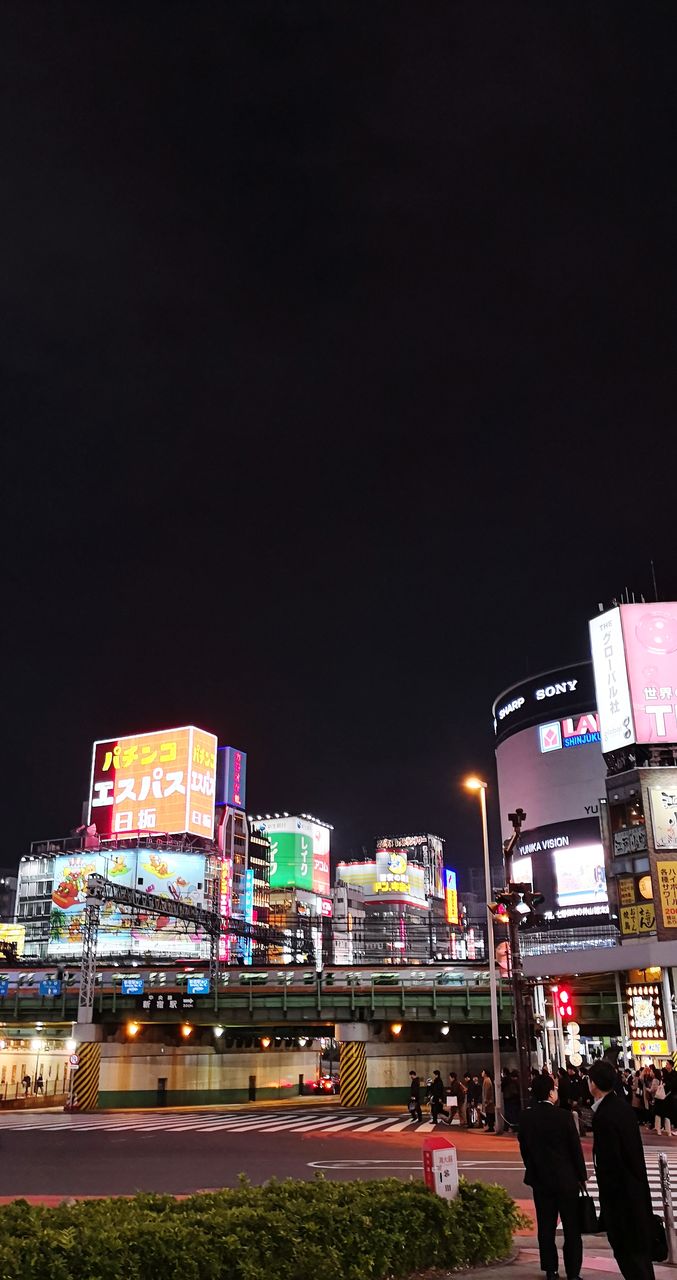 VIEW OF ILLUMINATED CITY AT NIGHT