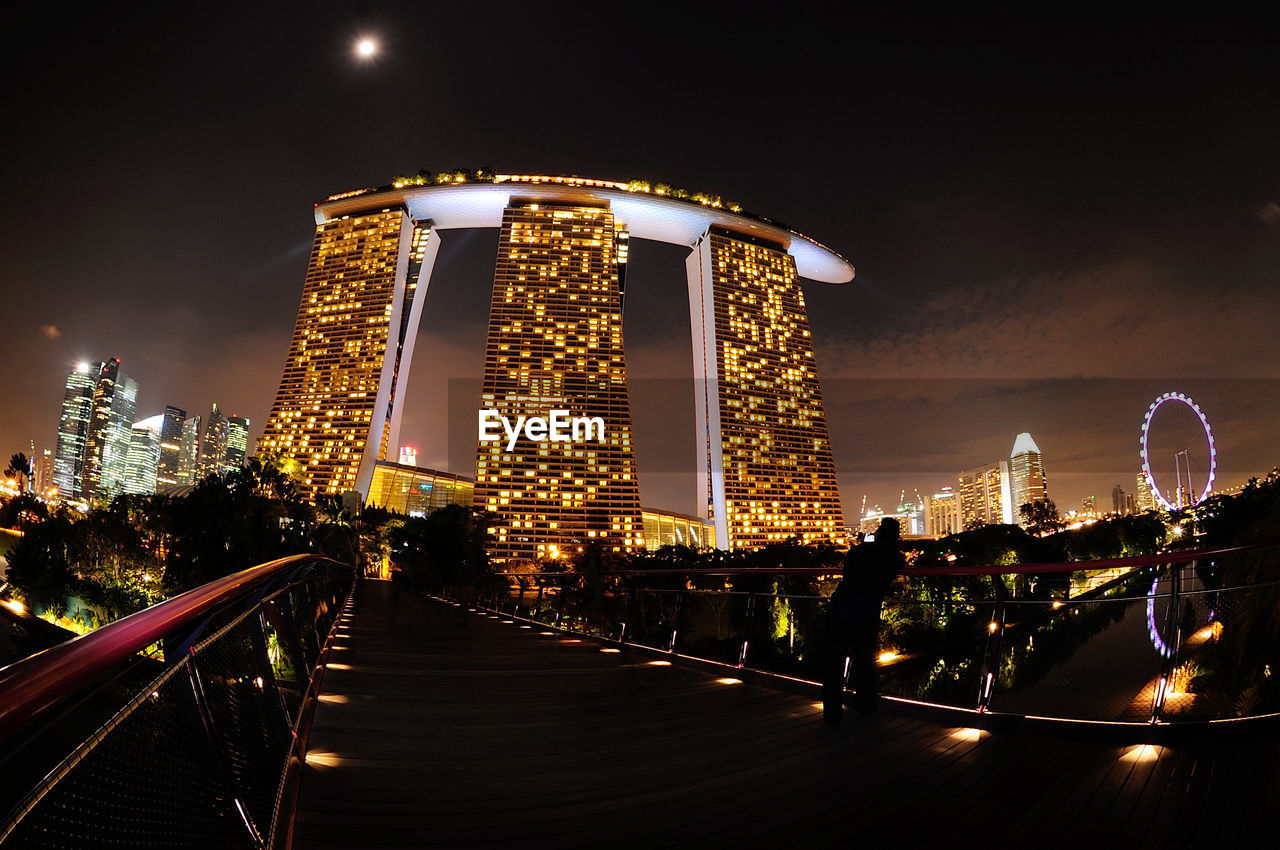 Bridge by building at night