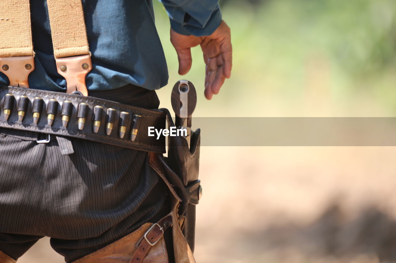 Rear view of man removing gun