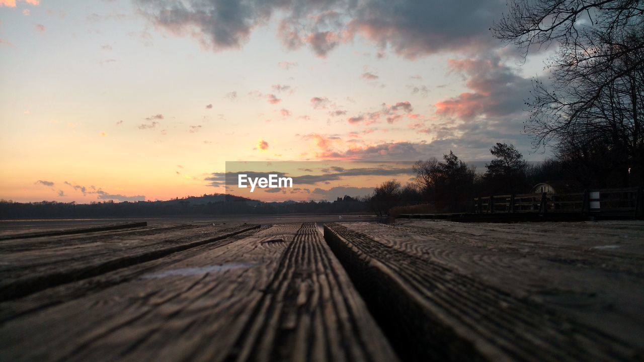 RAILROAD TRACK AGAINST SKY DURING SUNSET