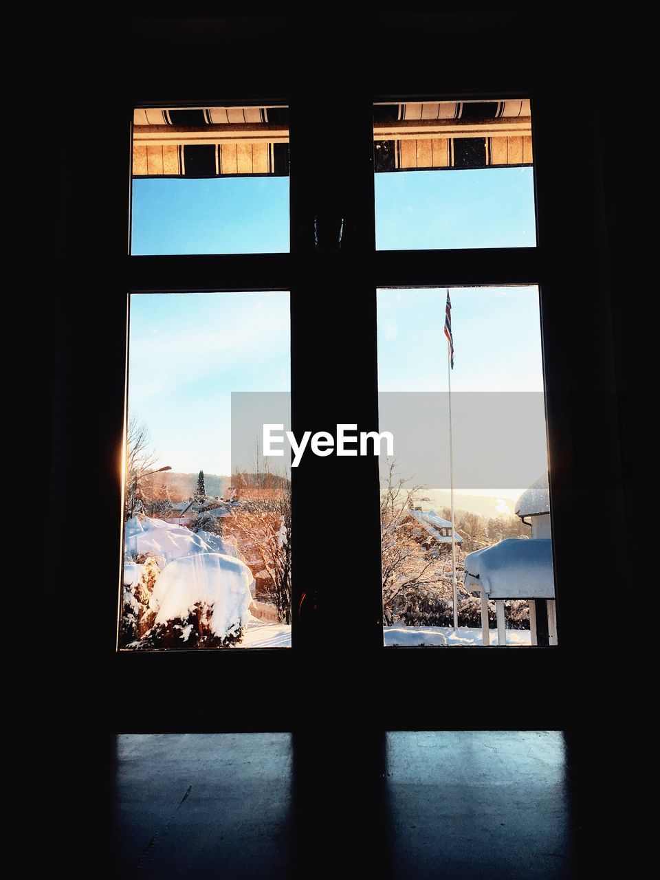 BUILDINGS SEEN THROUGH WINDOW DURING WINTER