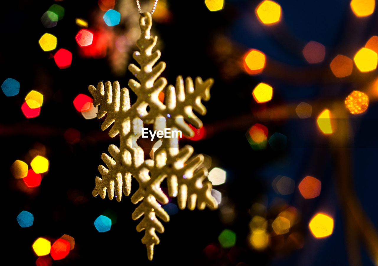 Close-up of christmas decoration against defocused lights