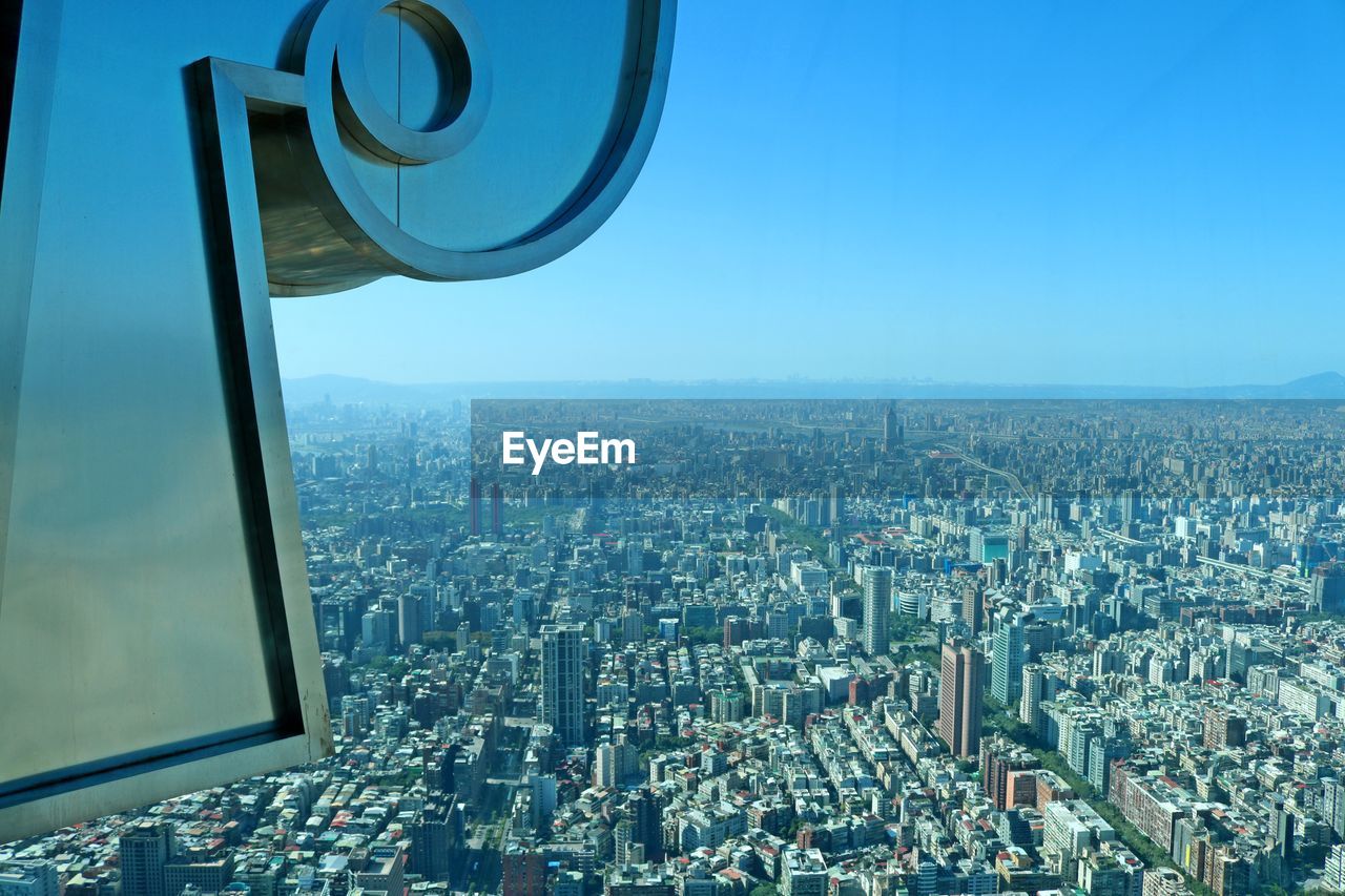 HIGH ANGLE VIEW OF CITYSCAPE AGAINST SKY