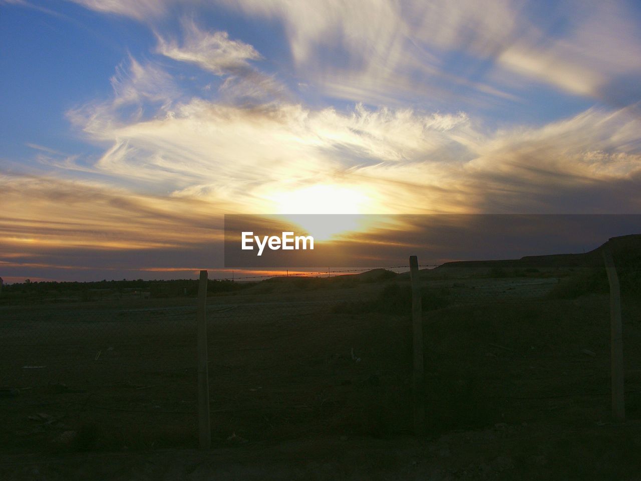 Scenic view of landscape against sky during sunset