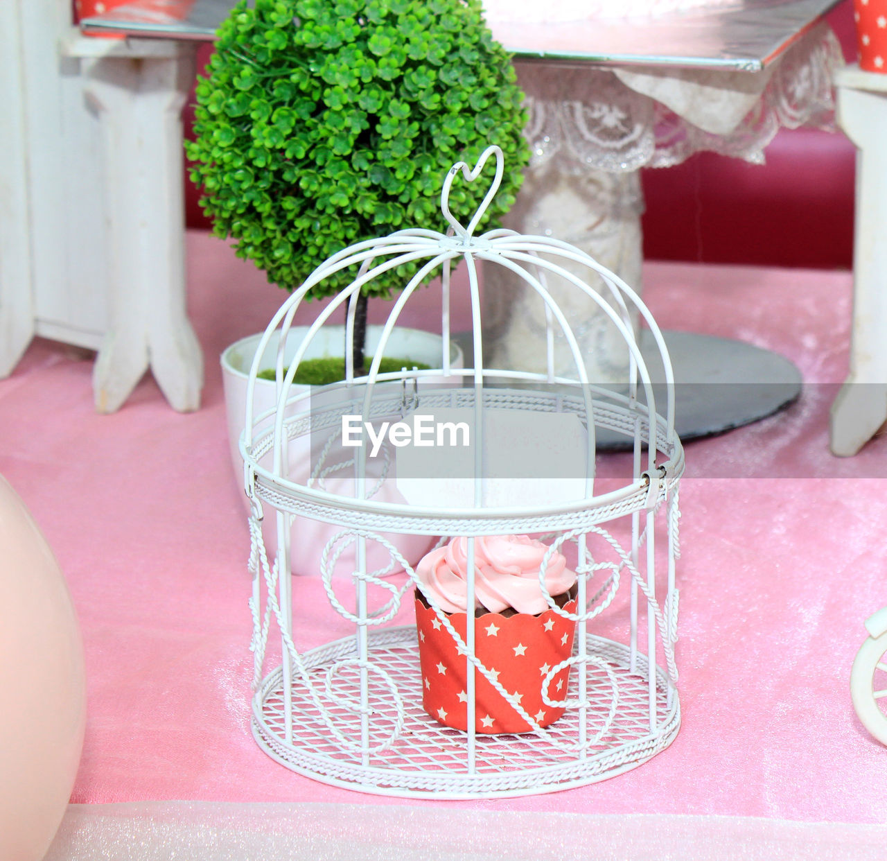 CLOSE-UP OF GLASS JAR ON TABLE AGAINST WINDOW