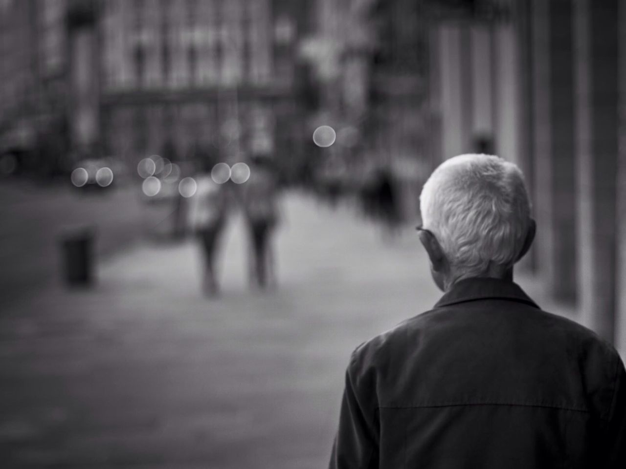 Rear view of senior man in street