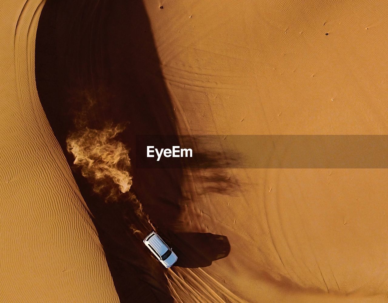 Directly above shot of off-road vehicle moving in desert