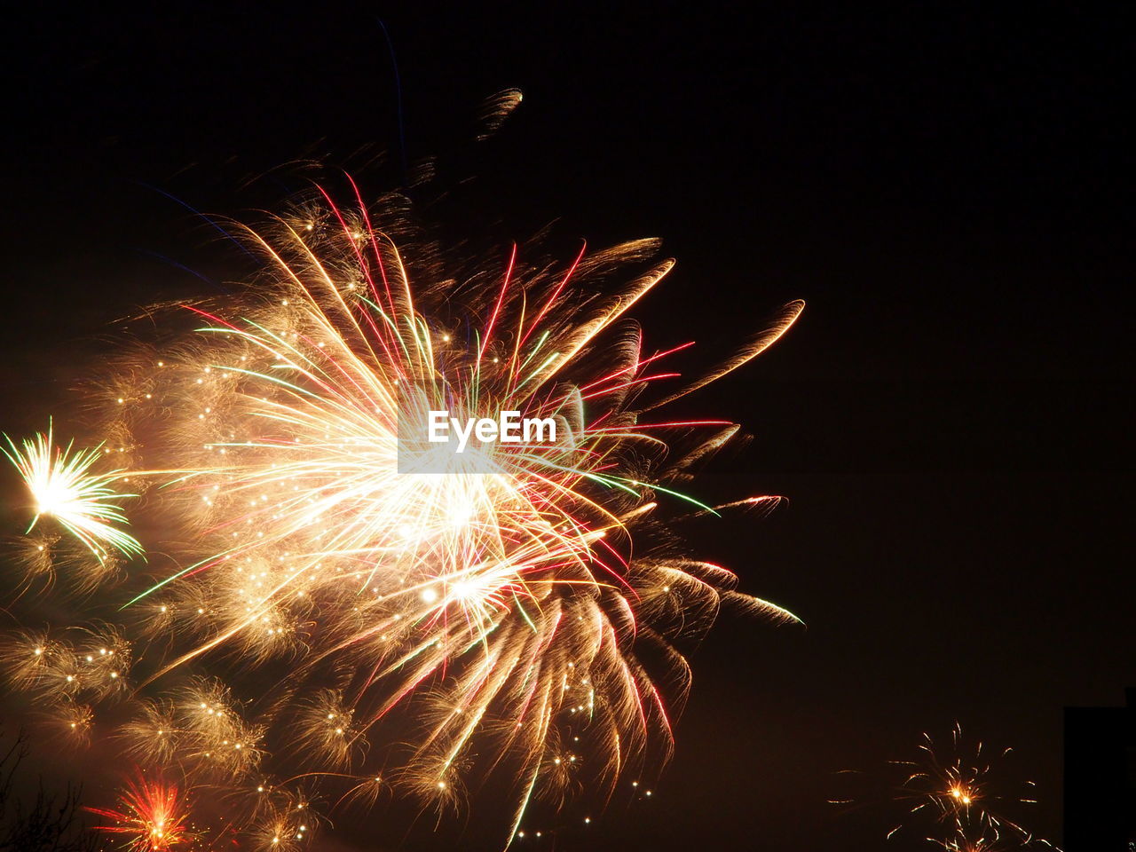LOW ANGLE VIEW OF FIREWORK DISPLAY IN SKY AT NIGHT