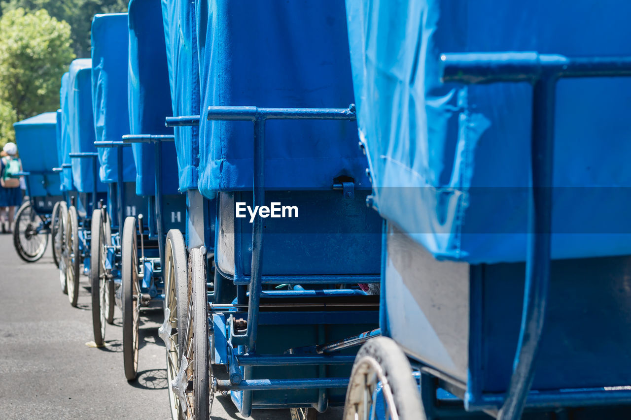 CLOSE-UP OF BICYCLE PARKED AGAINST BLUE WALL