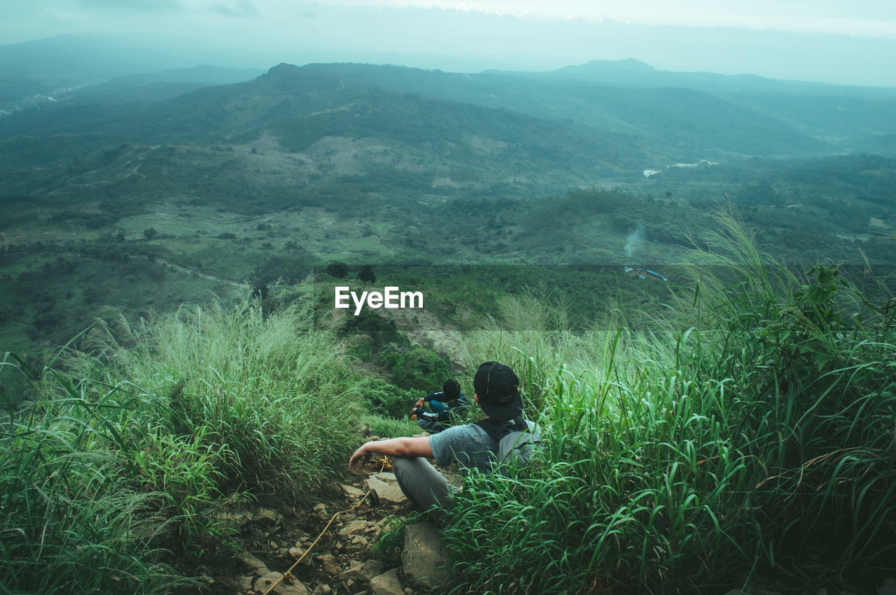 High angle view of men sitting on mountain