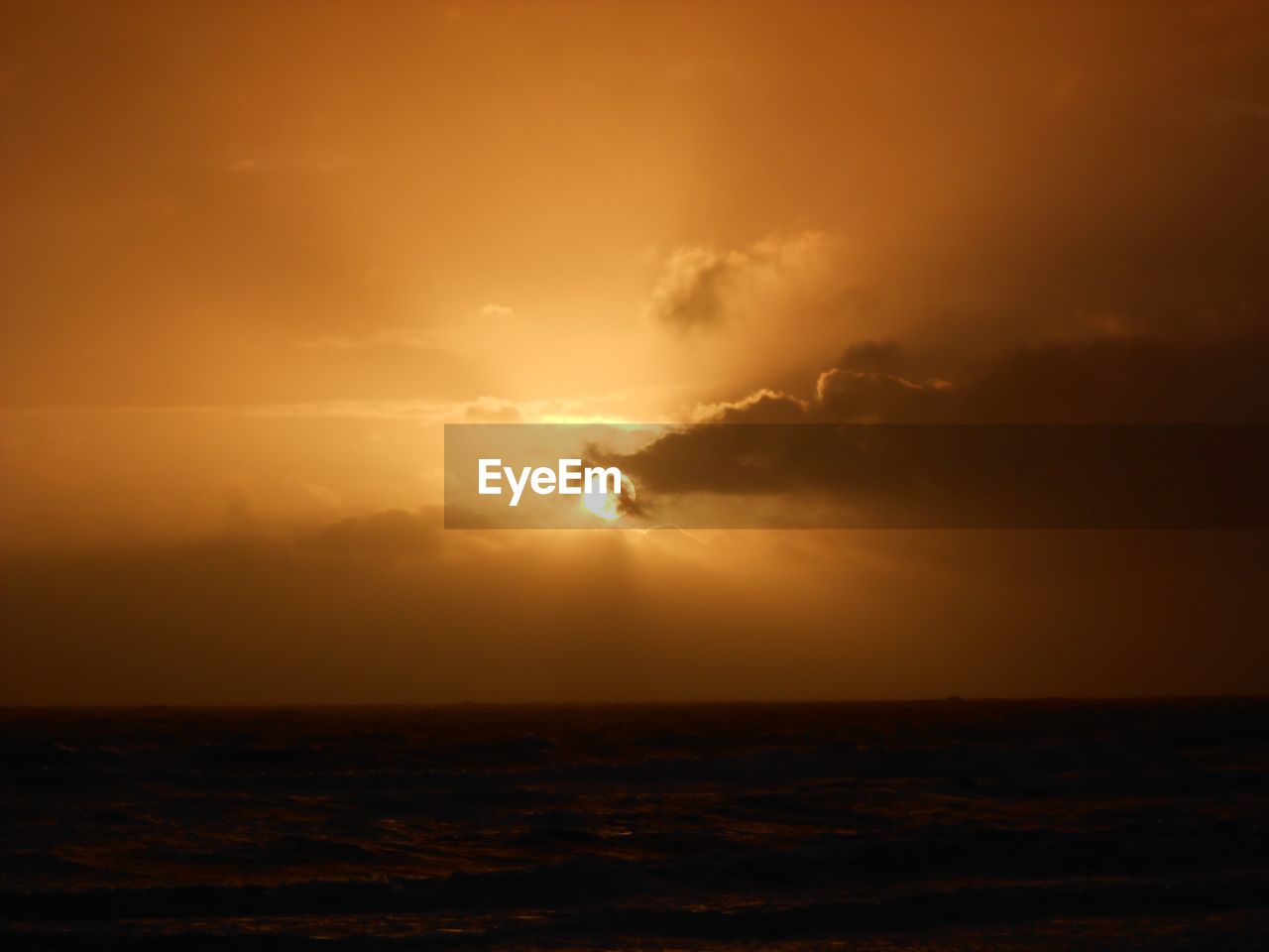 SCENIC VIEW OF SUNSET OVER SEA