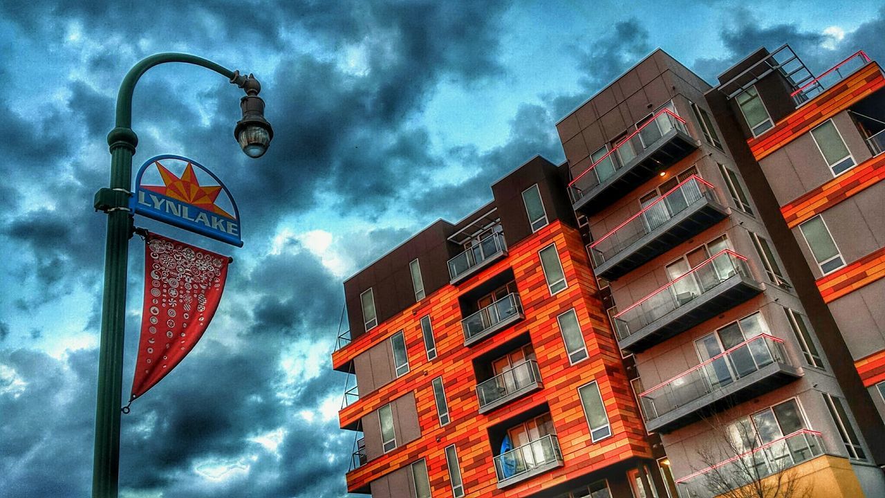 LOW ANGLE VIEW OF BUILDINGS AGAINST CLOUDY SKY