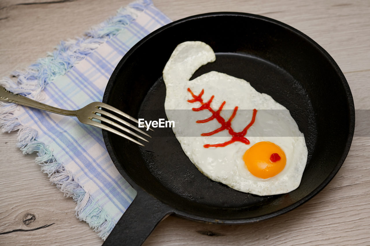 Abstract breakfast fried egg fish shape with fish skeleton