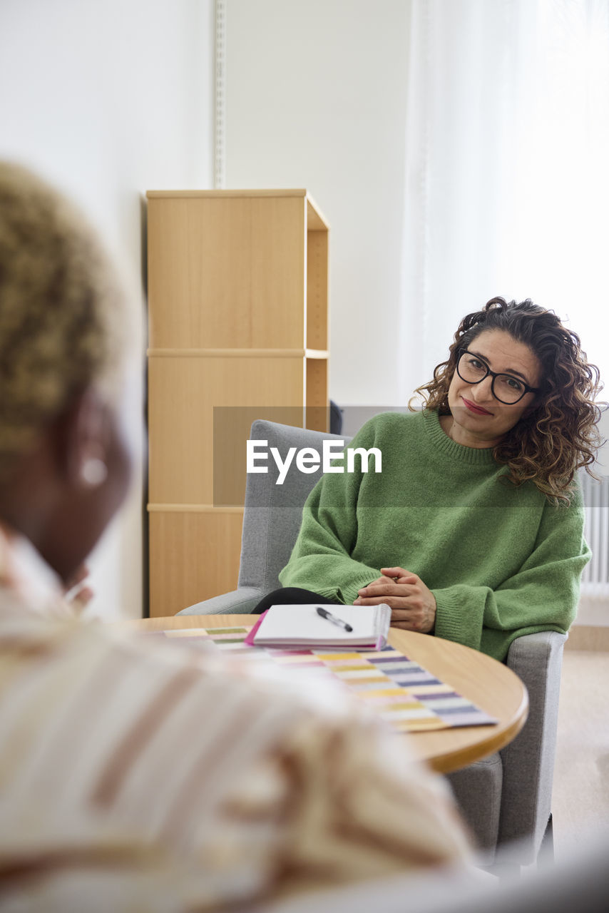Female therapist talking to patient during appointment