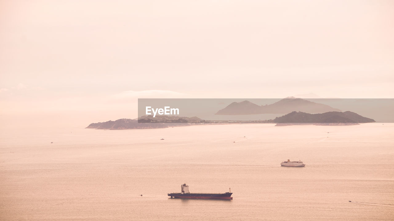 FISHING BOAT IN SEA AGAINST SKY