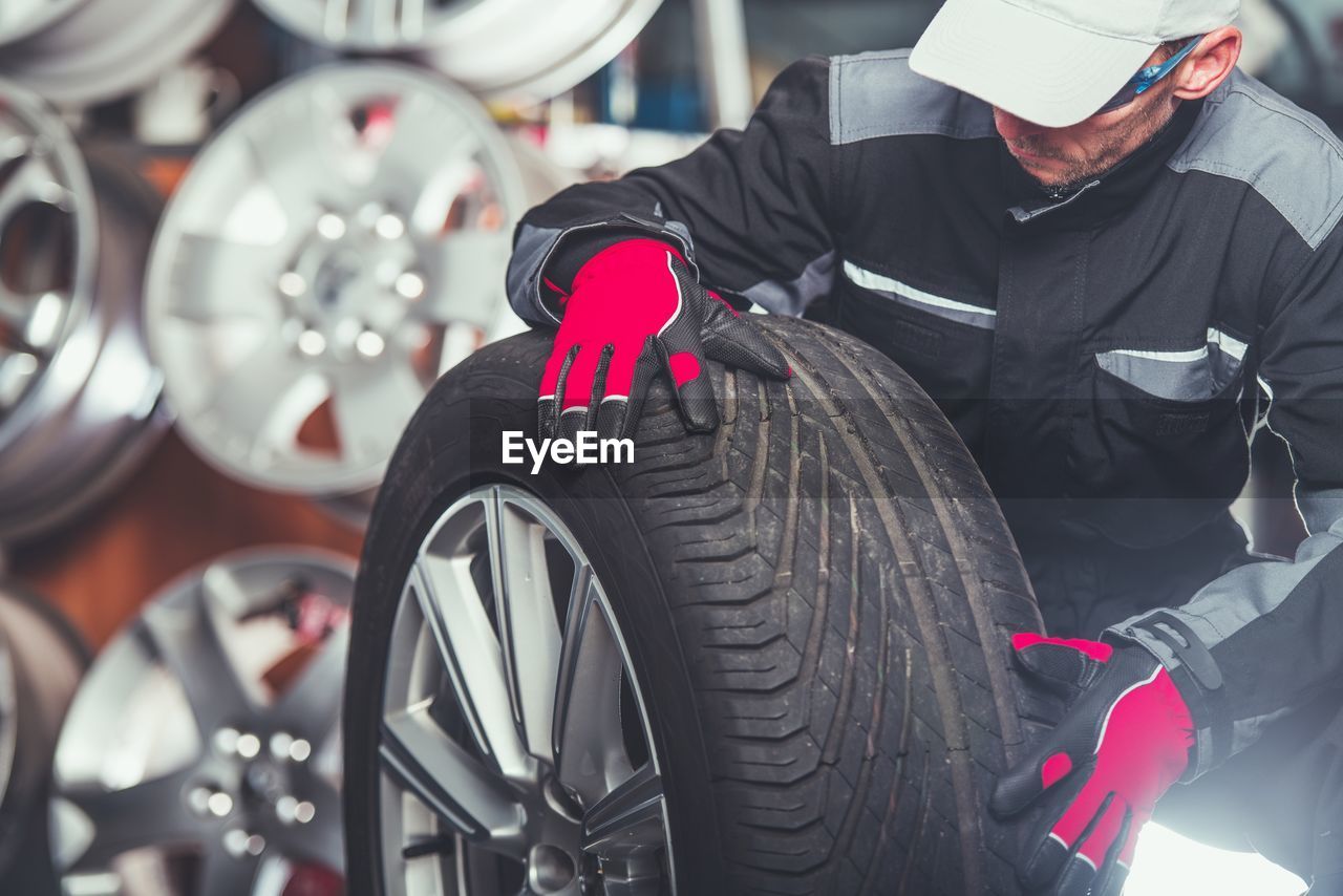 Mechanic looking at tire in garage