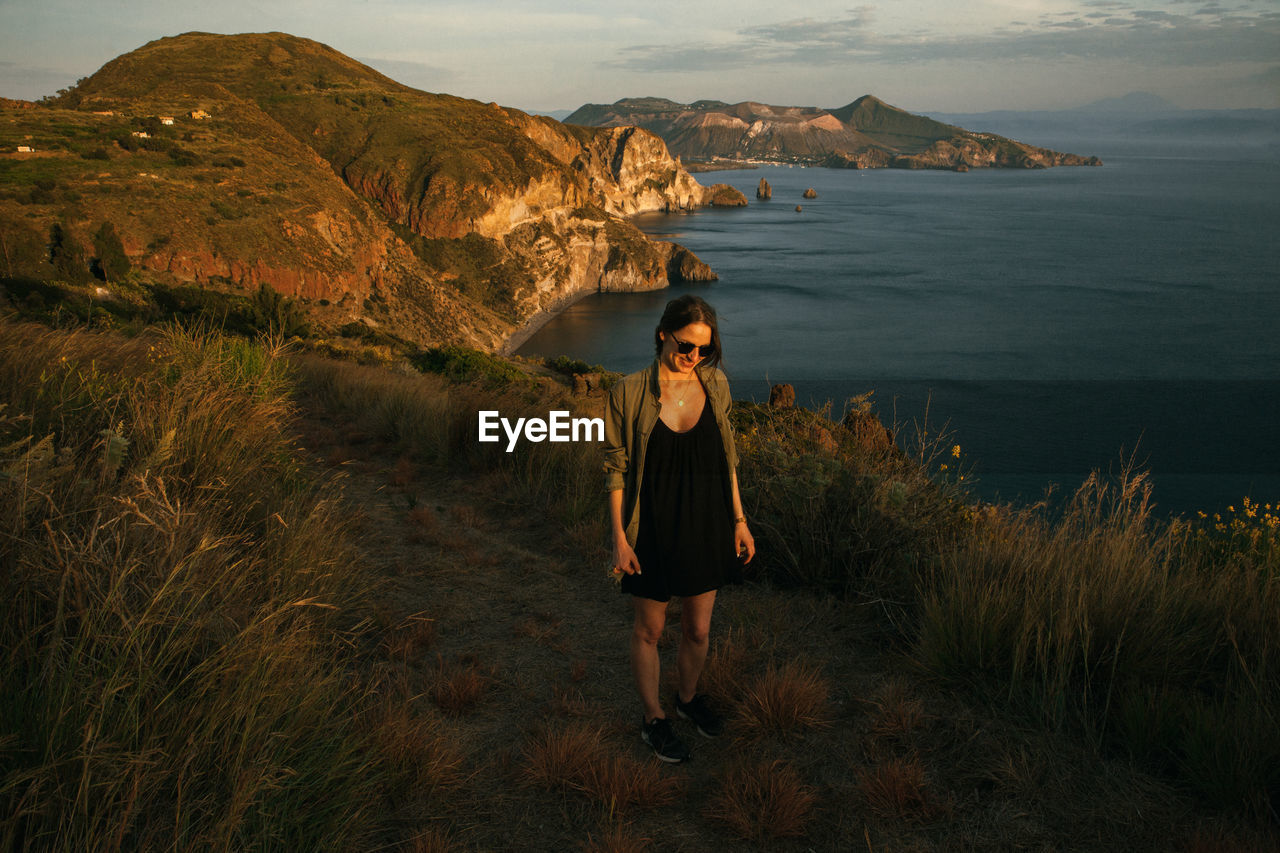 Full length of woman standing against landscape