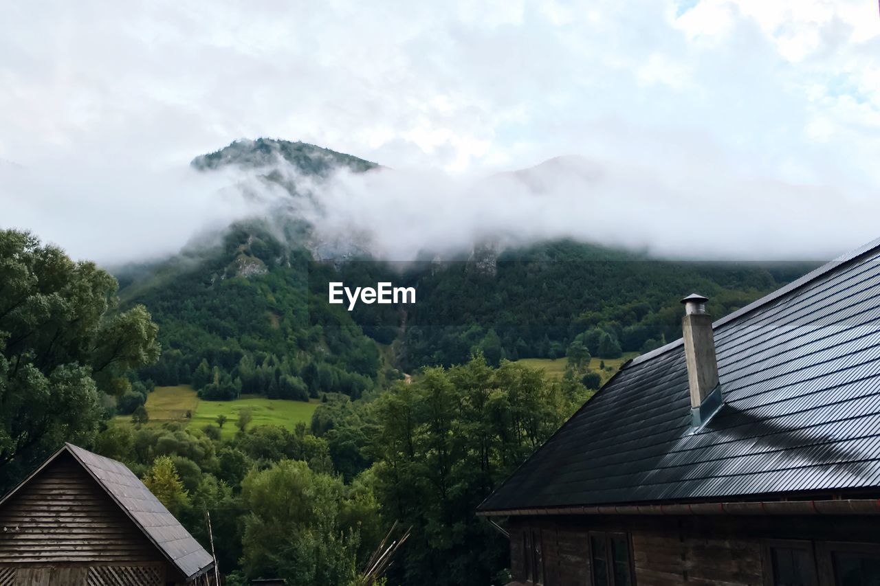 Low angle view of house on mountain against sky