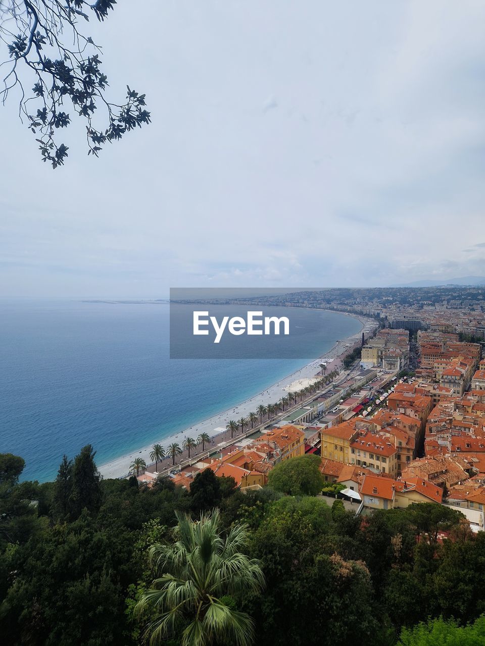 High angle view of townscape by sea against sky