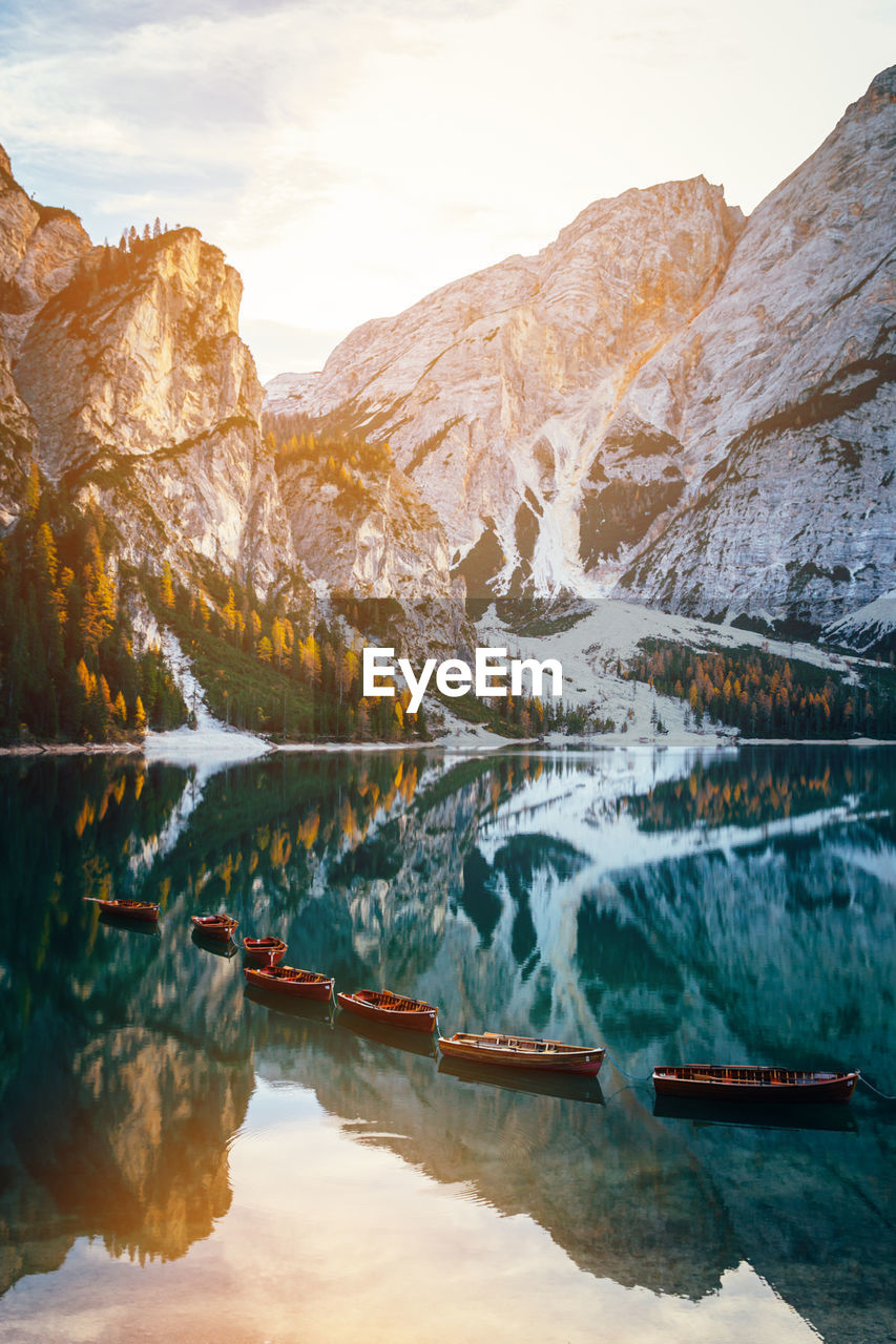 Scenic view of lake by snowcapped mountains against sky