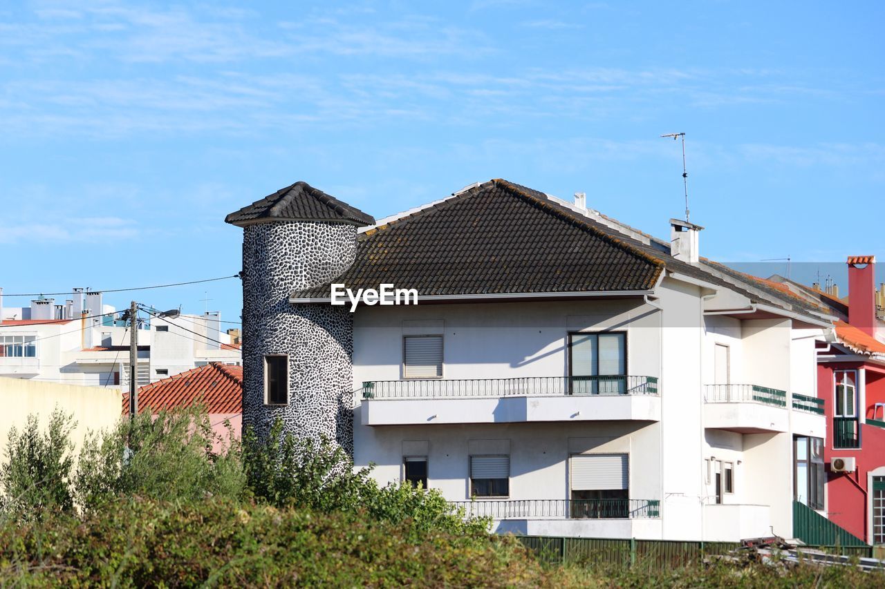 BUILDINGS AGAINST BLUE SKY