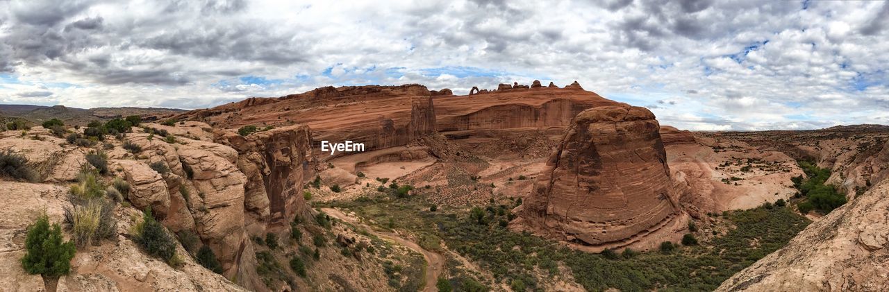 Panoramic view of arches national park against cloudy sky