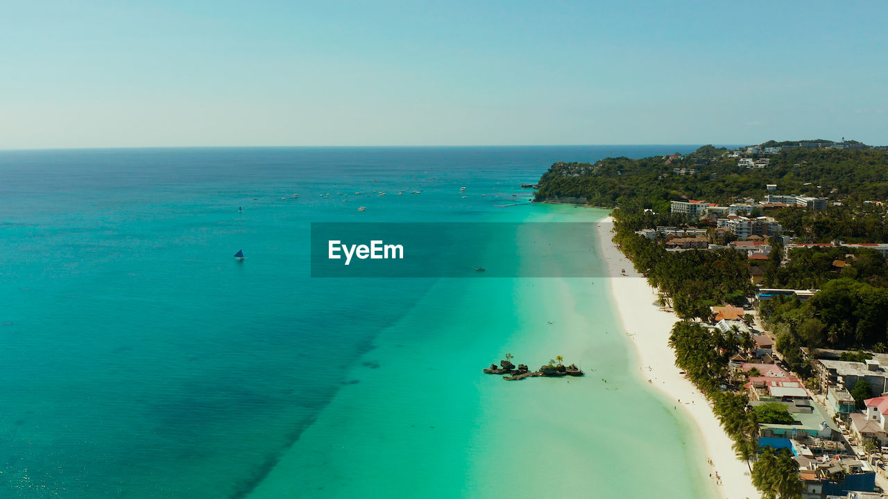 Tropical beach with tourists and clear blue sea, top view. boracay, philippines
